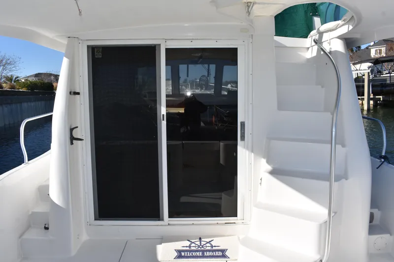  Yacht Photos Pics 2001 Mainship 390 yacht with sliding doors and exterior staircase.