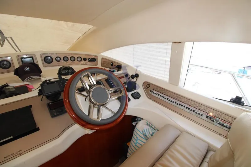  Yacht Photos Pics Cockpit of 2004 Enterprise Marine 43 FLY yacht with steering wheel and control panel.