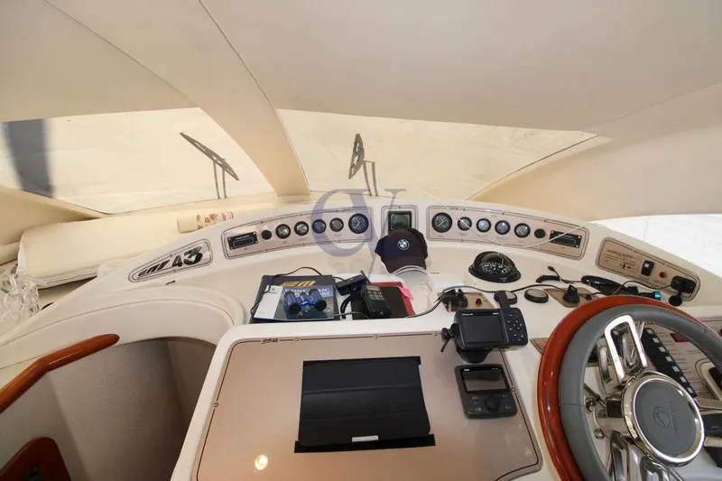  Yacht Photos Pics Cockpit of 2004 Enterprise Marine 43 FLY yacht with steering wheel and navigation instruments.