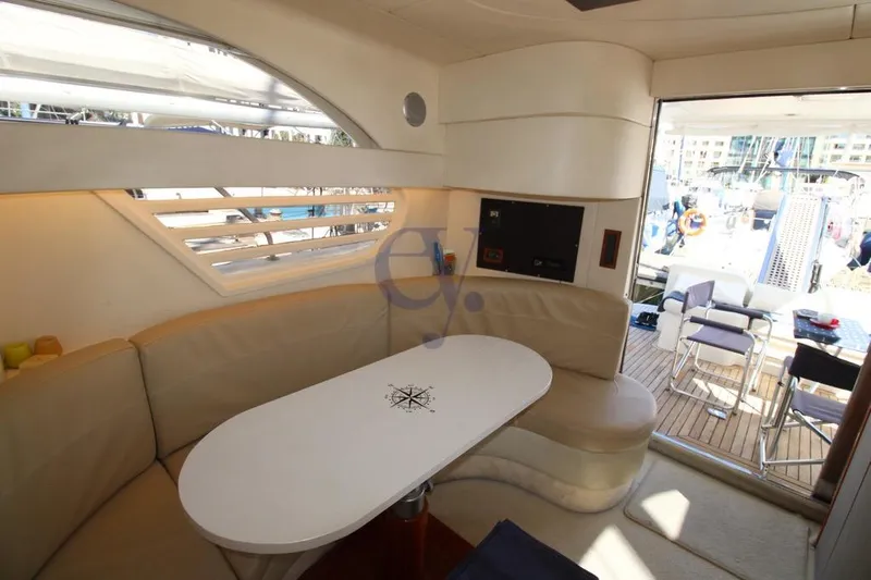 Yacht Photos Pics Luxurious interior of 2004 Enterprise Marine 43 FLY yacht with elegant seating and table.