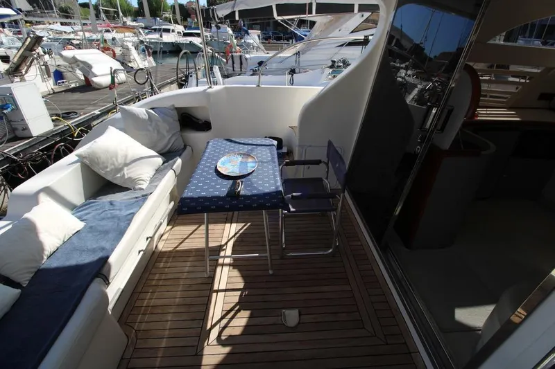  Yacht Photos Pics Luxurious 2004 Enterprise Marine 43 FLY yacht deck with seating and table.