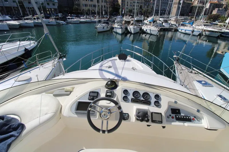  Yacht Photos Pics Cockpit view of 2004 Enterprise Marine 43 FLY yacht in a marina.