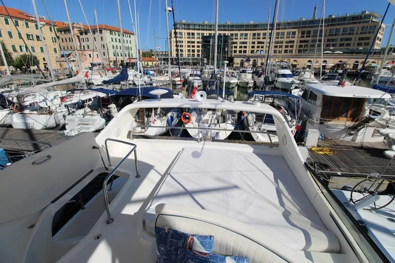  Yacht Photos Pics Luxury 2004 Enterprise Marine 43 FLY yacht docked in a bustling marina.