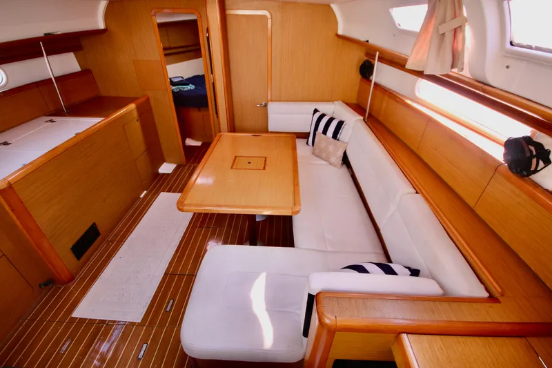 Vela Via Yacht Photos Pics Interior of 2009 Jeanneau 44i sailboat with wooden finish and white seating.