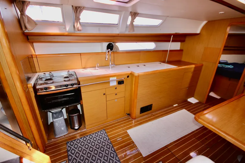 Vela Via Yacht Photos Pics Interior of 2009 Jeanneau 44i yacht featuring a modern kitchen with wood finish.