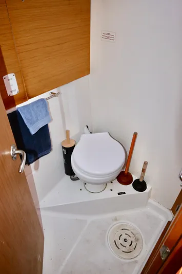 Vela Via Yacht Photos Pics 2009 Jeanneau 44i yacht bathroom with toilet, towel, and cleaning tools.