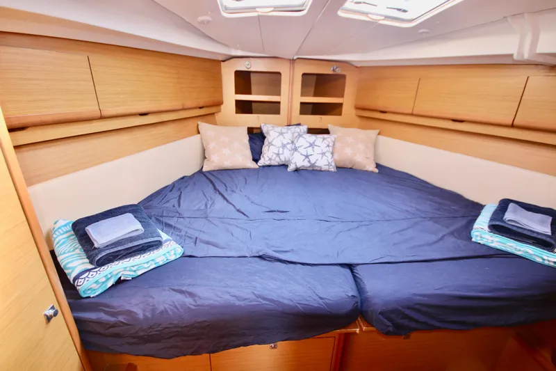 Vela Via Yacht Photos Pics Luxurious cabin interior of 2009 Jeanneau 44i sailboat with cozy bedding and storage.