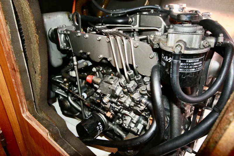 Vela Via Yacht Photos Pics Engine compartment of a 2009 Jeanneau 44i sailboat, showcasing mechanical components and hoses.