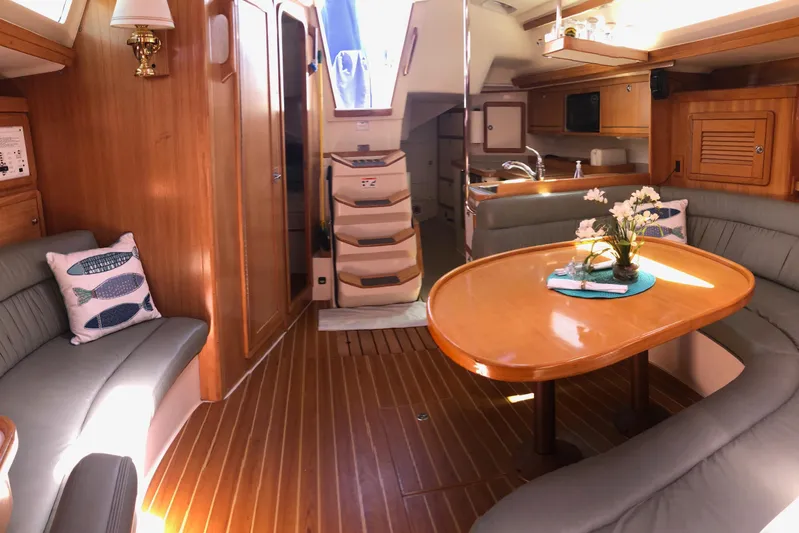 Makani Yacht Photos Pics Luxurious interior of a 2008 Catalina 42 MkII sailboat with elegant wood finishes.