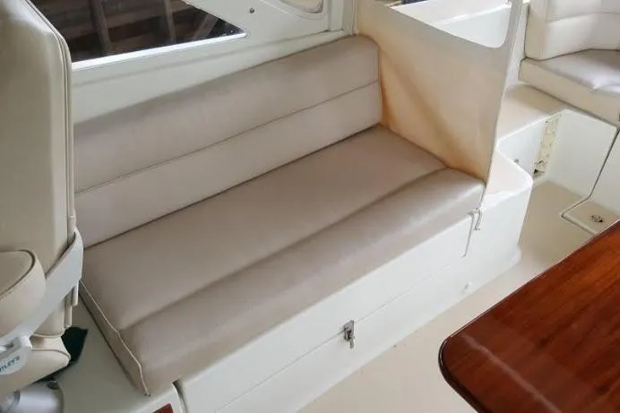 True Love Yacht Photos Pics 2009 MJM 29z Express boat interior with beige seating and wooden table.