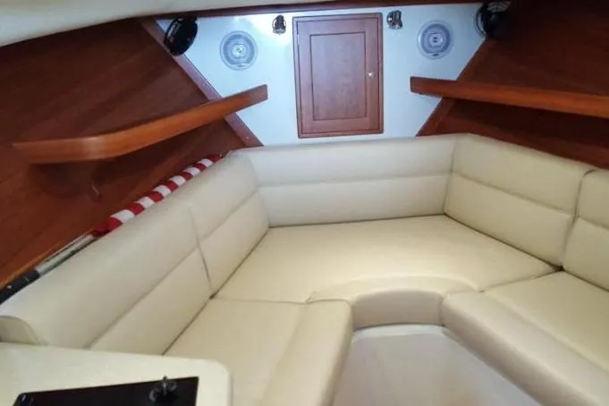 True Love Yacht Photos Pics 2009 MJM 29z Express cabin interior with beige seating and wooden accents.