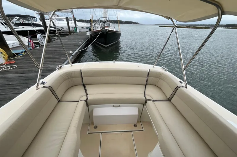 True Love Yacht Photos Pics 2009 MJM 29z Express boat with beige seating, docked by the water.
