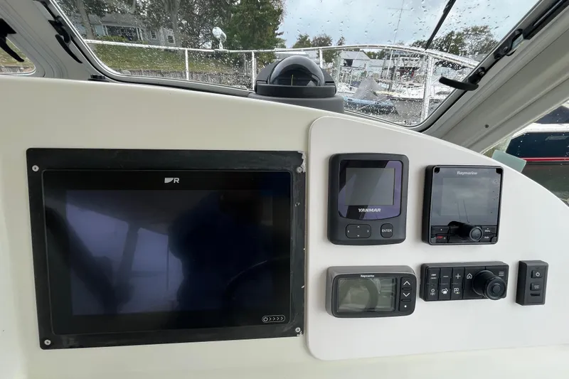 True Love Yacht Photos Pics Dashboard of a 2009 MJM 29z Express boat with navigation and control instruments.