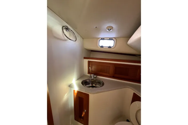 True Love Yacht Photos Pics 2009 MJM 29z Express boat interior with sink and wooden cabinets.