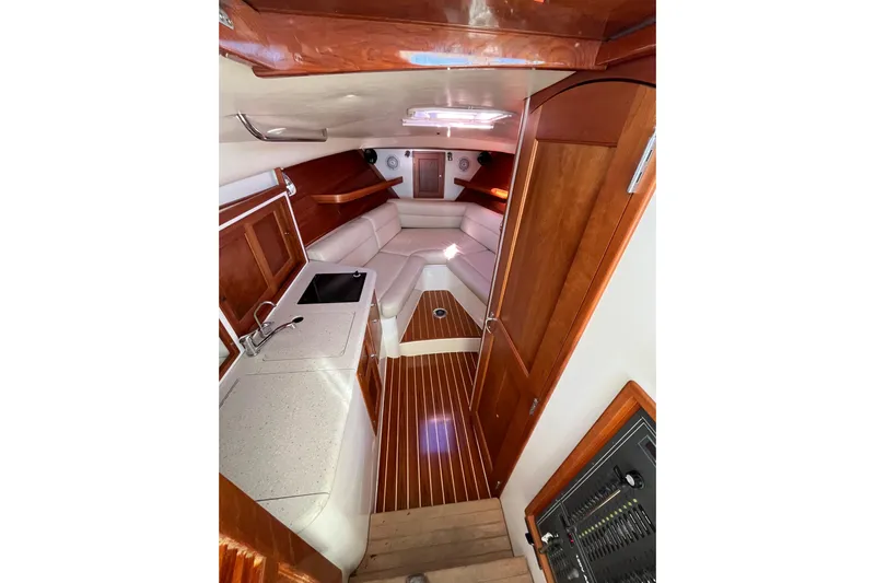 True Love Yacht Photos Pics Luxurious interior of 2009 MJM 29z Express boat with wood finishes and seating area.