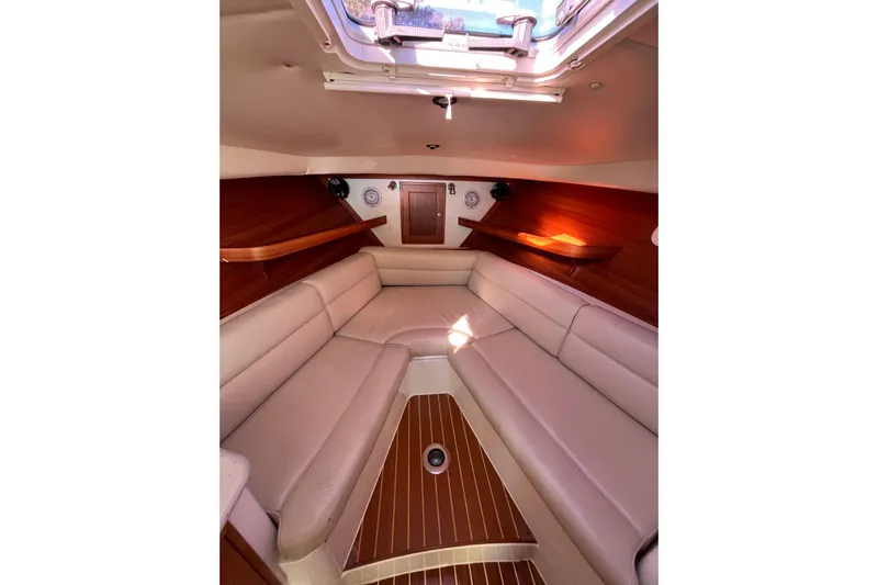 True Love Yacht Photos Pics 2009 MJM 29z Express cabin interior with beige seating and wooden accents.