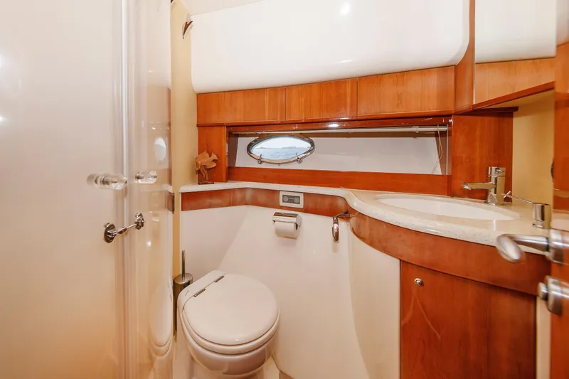 Tool N' Around Yacht Photos Pics Luxurious bathroom in 2005 Aicon Yachts 56 Flybridge, featuring wood accents and modern fixtures.