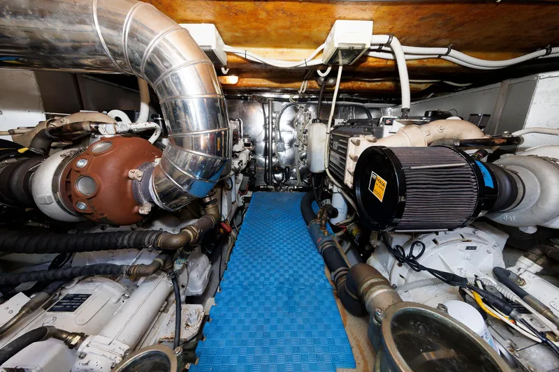 Tool N' Around Yacht Photos Pics Engine room of 2005 Aicon Yachts 56 Flybridge with visible machinery and piping.
