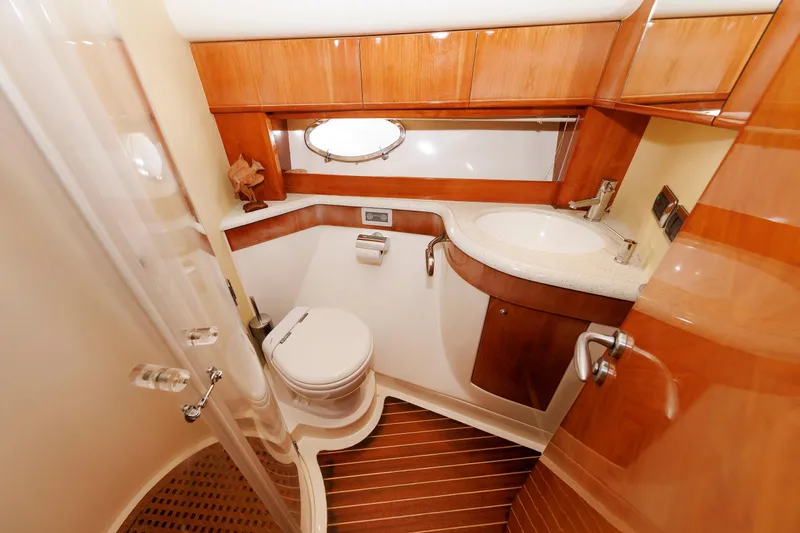 Tool N' Around Yacht Photos Pics Luxurious bathroom in 2005 Aicon Yachts 56 Flybridge with wood accents and modern fixtures.