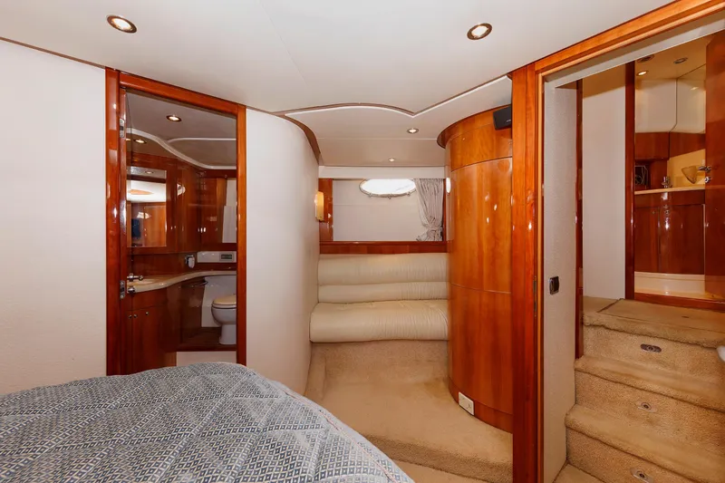 Tool N' Around Yacht Photos Pics Luxurious interior of 2005 Aicon Yachts 56 Flybridge, featuring wood finishes and cozy seating.