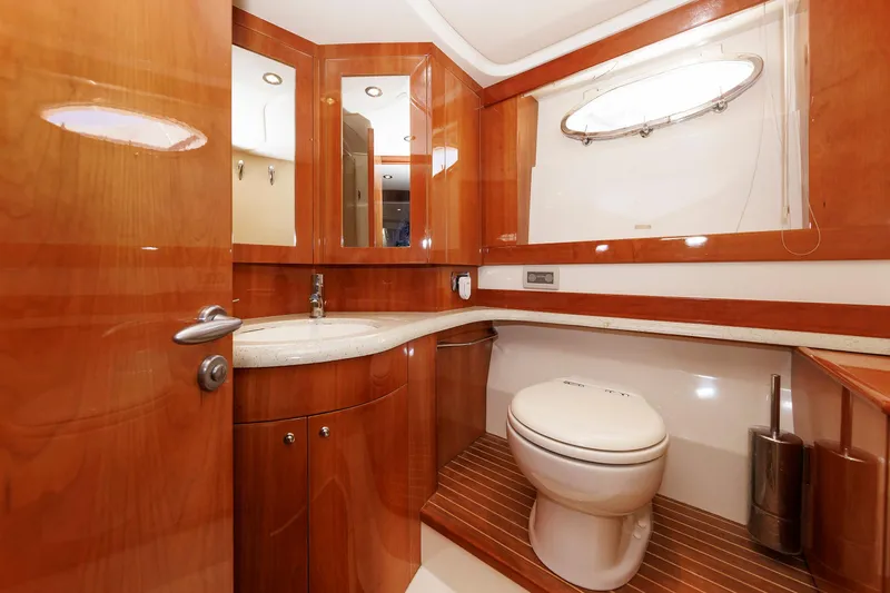 Tool N' Around Yacht Photos Pics Luxurious bathroom in 2005 Aicon Yachts 56 Flybridge, featuring wood accents and modern fixtures.