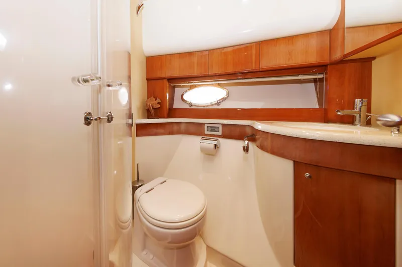 Tool N' Around Yacht Photos Pics Luxurious bathroom in 2005 Aicon Yachts 56 Flybridge, featuring elegant wood finishes.