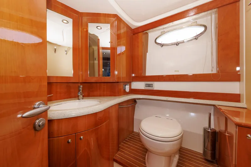 Tool N' Around Yacht Photos Pics Luxurious bathroom in 2005 Aicon Yachts 56 Flybridge, featuring wood accents and modern fixtures.