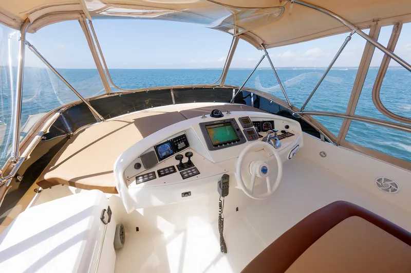 Tool N' Around Yacht Photos Pics Flybridge helm of 2005 Aicon Yachts 56, featuring navigation controls and ocean view.
