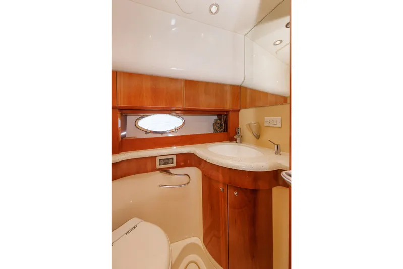 Tool N' Around Yacht Photos Pics Luxurious bathroom in 2005 Aicon Yachts 56 Flybridge, featuring elegant wood finishes and modern fixtures.