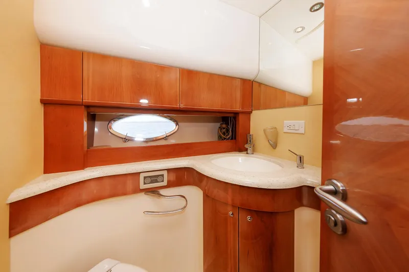Tool N' Around Yacht Photos Pics Luxurious bathroom in 2005 Aicon Yachts 56 Flybridge, featuring elegant wood cabinetry and modern fixtures.
