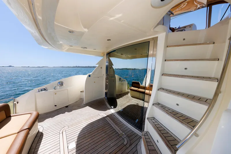Tool N' Around Yacht Photos Pics Luxurious 2005 Aicon Yachts 56 Flybridge with elegant deck and ocean view.