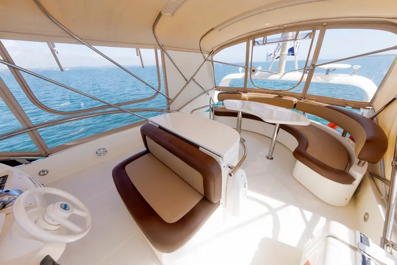 Tool N' Around Yacht Photos Pics Luxurious 2005 Aicon Yachts 56 Flybridge interior with elegant seating and ocean view.