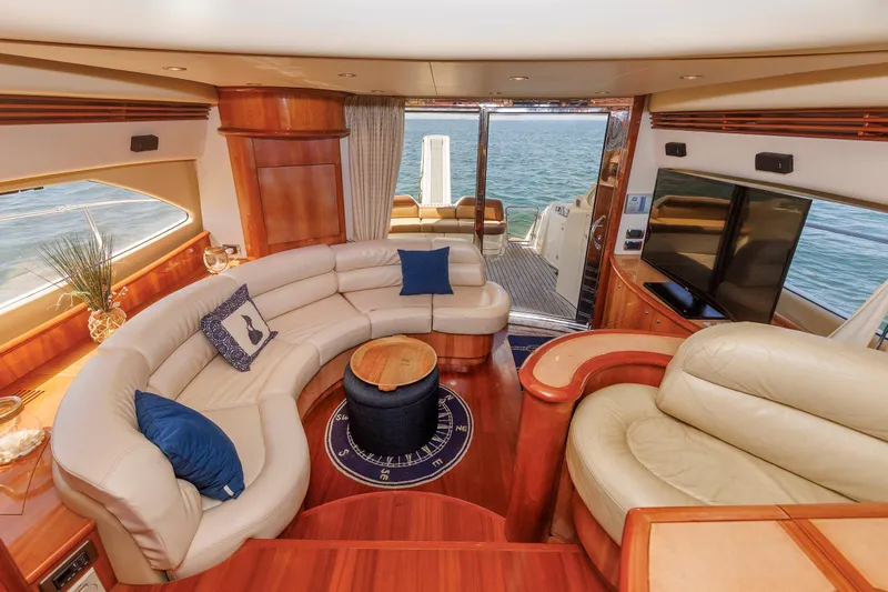 Tool N' Around Yacht Photos Pics Luxurious interior of 2005 Aicon Yachts 56 Flybridge with elegant seating and ocean view.