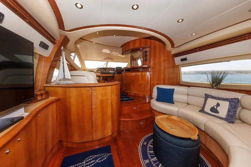 Tool N' Around Yacht Photos Pics Luxurious interior of 2005 Aicon Yachts 56 Flybridge with elegant wood finish and plush seating.