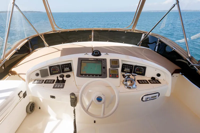 Tool N' Around Yacht Photos Pics Flybridge helm of 2005 Aicon Yachts 56, featuring navigation controls and ocean view.