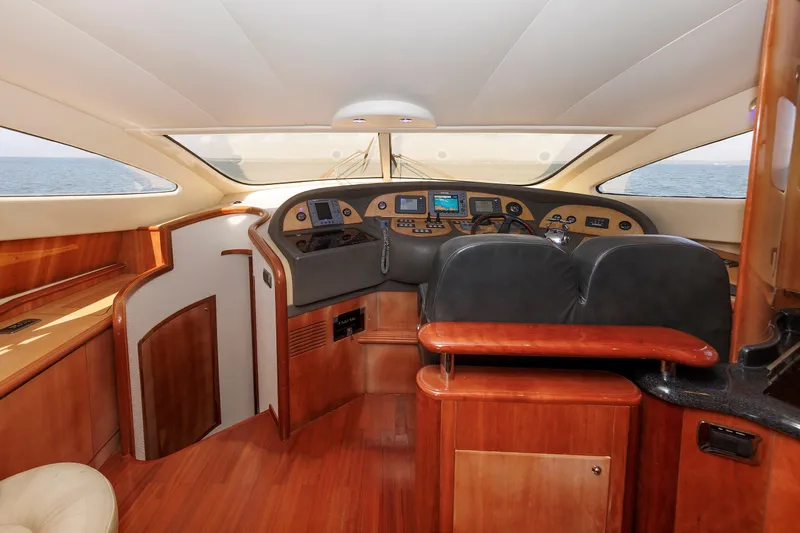 Tool N' Around Yacht Photos Pics Luxurious interior of 2005 Aicon Yachts 56 Flybridge, featuring elegant wood finishes and modern controls.