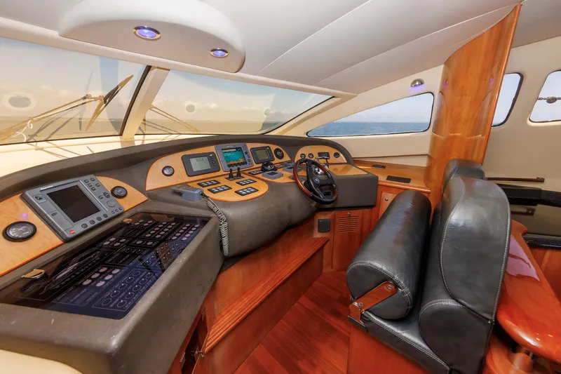 Tool N' Around Yacht Photos Pics Luxurious 2005 Aicon Yachts 56 Flybridge helm with advanced navigation systems and leather seating.