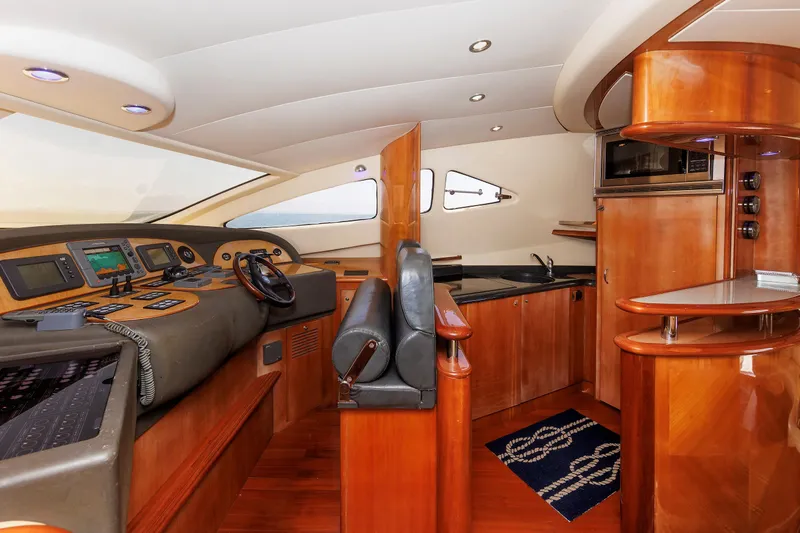 Tool N' Around Yacht Photos Pics Luxurious interior of 2005 Aicon Yachts 56 Flybridge with modern helm and kitchenette.