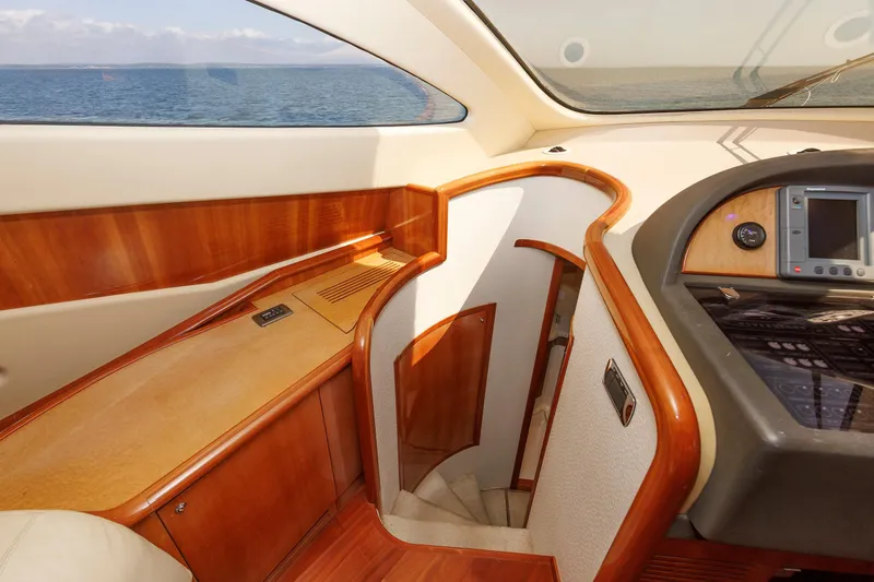 Tool N' Around Yacht Photos Pics Luxurious interior of 2005 Aicon Yachts 56 Flybridge with wood accents and ocean view.