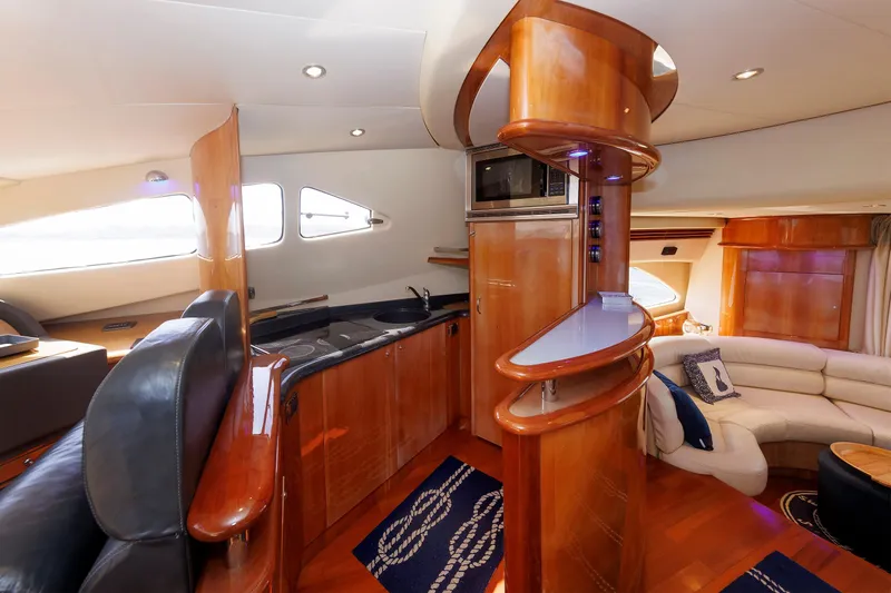 Tool N' Around Yacht Photos Pics Luxurious interior of 2005 Aicon Yachts 56 Flybridge with modern kitchen and seating area.