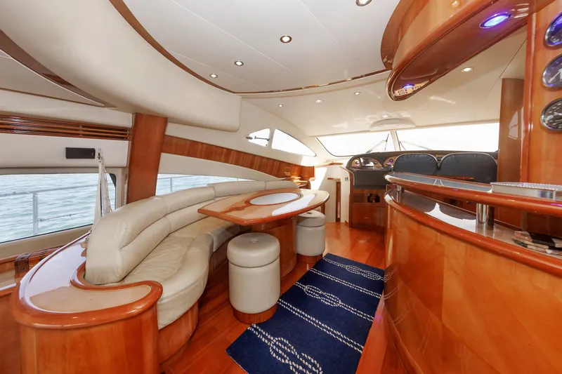 Tool N' Around Yacht Photos Pics Luxurious interior of 2005 Aicon Yachts 56 Flybridge with elegant wood finishes and plush seating.
