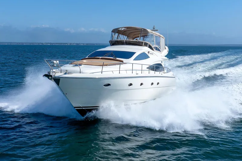 Tool N' Around Yacht Photos Pics Aicon Yachts 56 Flybridge 2005 cruising on open sea, creating dynamic waves.