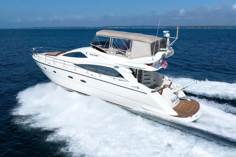 Tool N' Around Yacht Photos Pics Aicon Yachts 56 Flybridge 2005 cruising on open sea, showcasing sleek design and luxury.