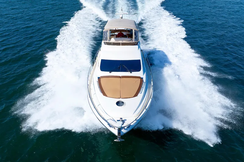 Tool N' Around Yacht Photos Pics Aicon Yachts 56 Flybridge 2005 cruising on open water, aerial view.