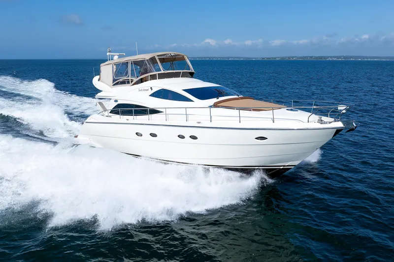 Tool N' Around Yacht Photos Pics Aicon Yachts 56 Flybridge 2005 cruising on open sea, showcasing sleek design and luxury.