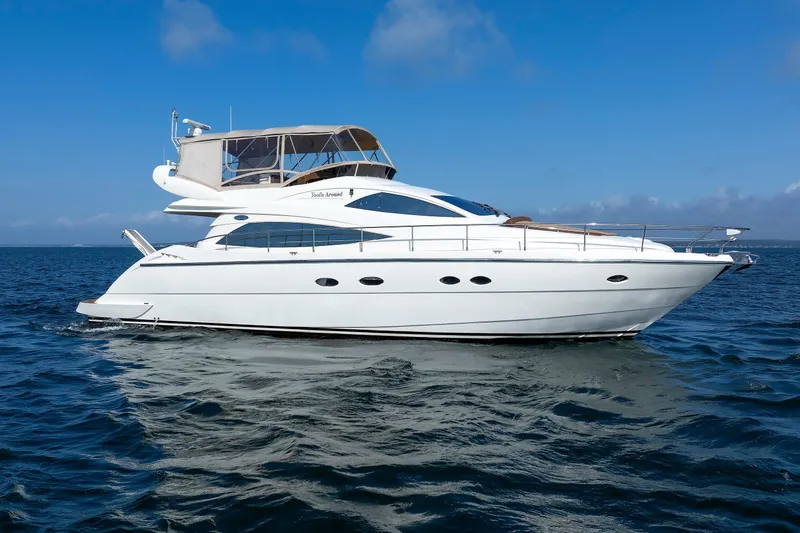 Tool N' Around Yacht Photos Pics Aicon Yachts 56 Flybridge 2005 cruising on open water under clear blue skies.
