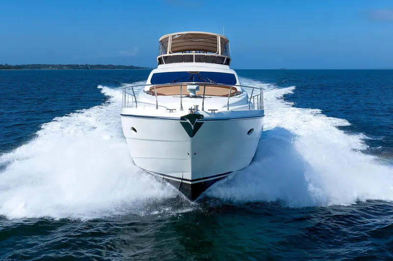 Tool N' Around Yacht Photos Pics Aicon Yachts 56 Flybridge 2005 cruising on open sea, creating dynamic waves.