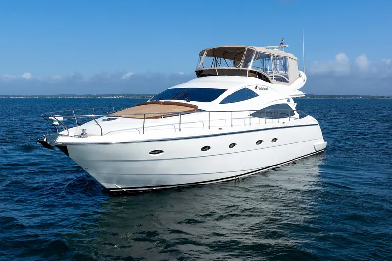 Tool N' Around Yacht Photos Pics Aicon Yachts 56 Flybridge 2005 cruising on open water under clear blue skies.