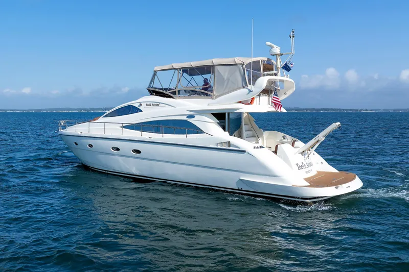 Tool N' Around Yacht Photos Pics Aicon Yachts 56 Flybridge 2005 cruising on open water under clear skies.