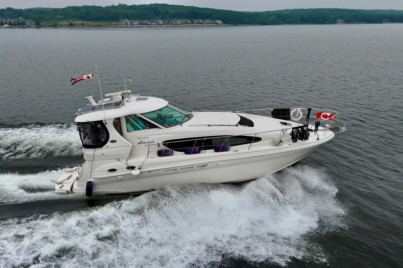 A Mi Manera Yacht Photos Pics 2007 Sea Ray 40 Motor Yacht cruising on a lake with Canadian flags.